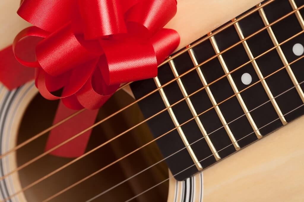 Guitar with a red bow on it